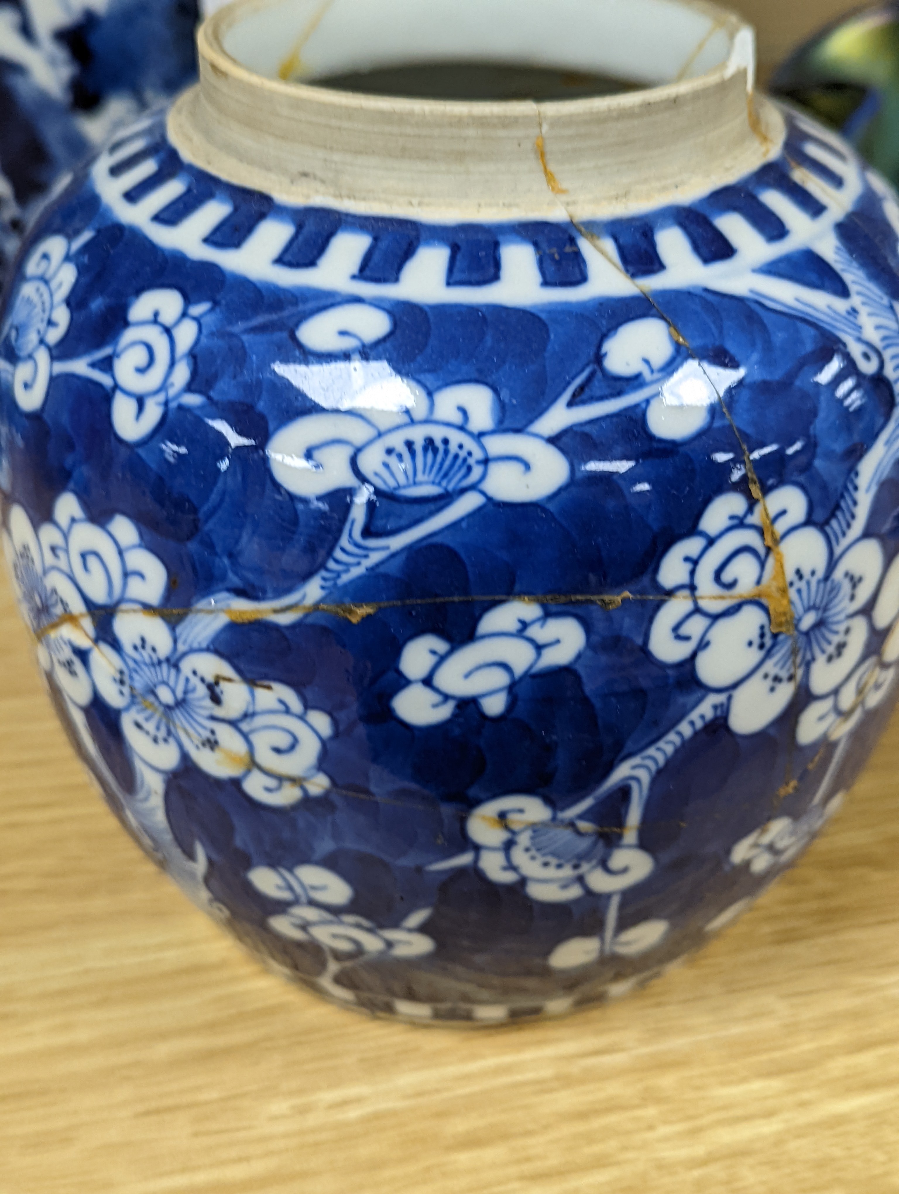 A pair of 19th century Chinese blue and white vases, a prunus vase and cover and a similar jar (4), pair of vases 24 cms high.